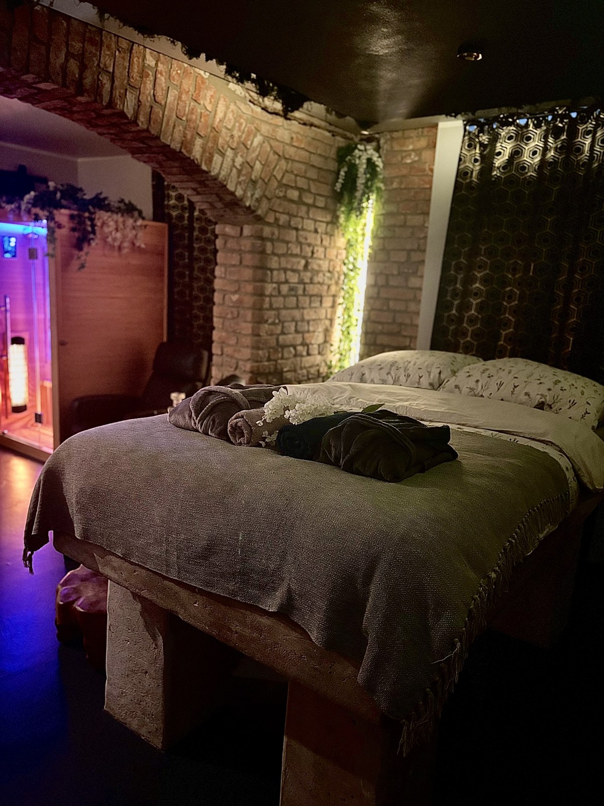 Styled bed with rolled towels and robes, sauna cabin visible in background — Property Presentation Reset, Poznań apartment