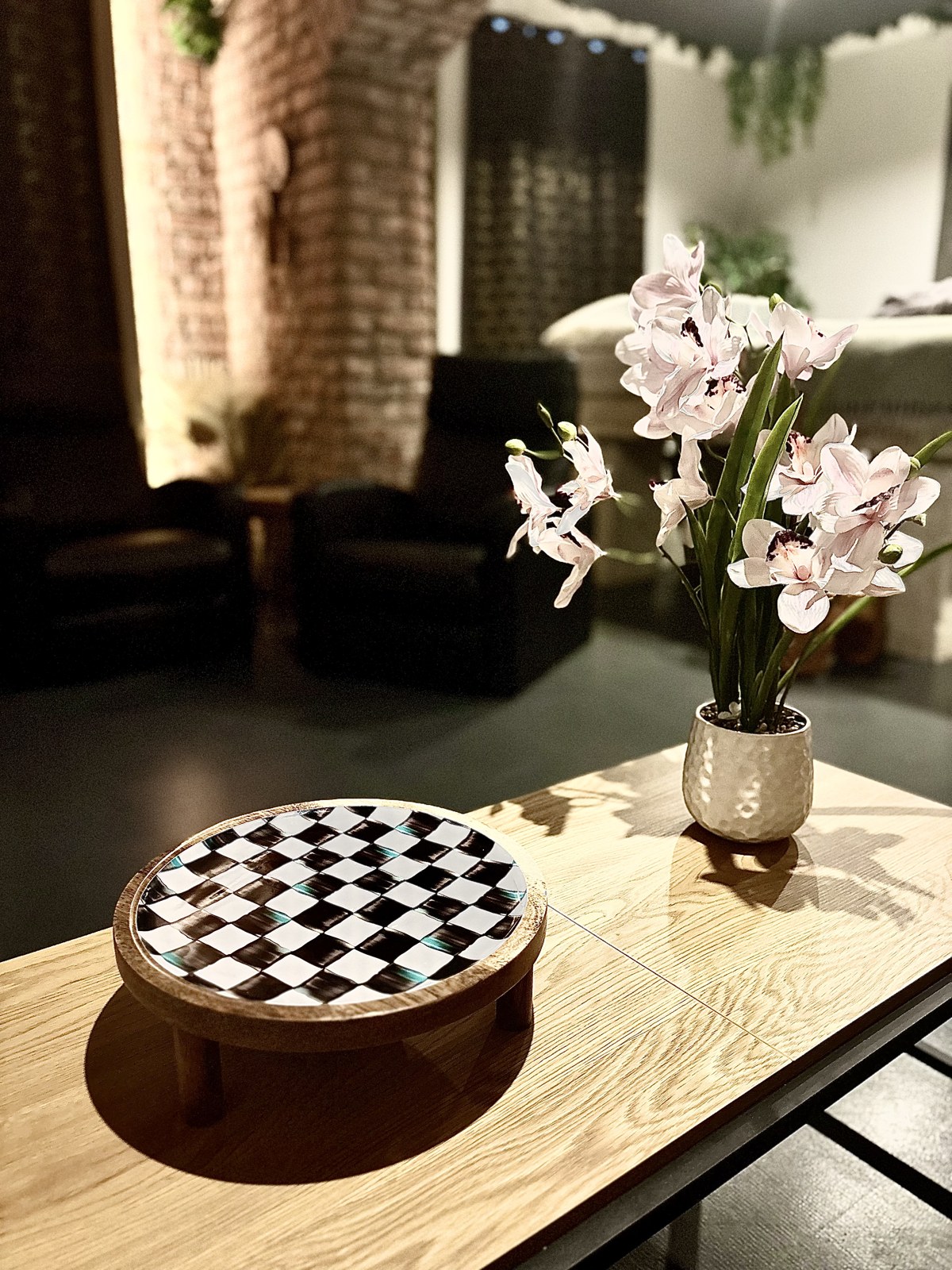 Checkered tray and orchid vase on a coffee table in the styled living area — Property Presentation Reset, Poznań apartment